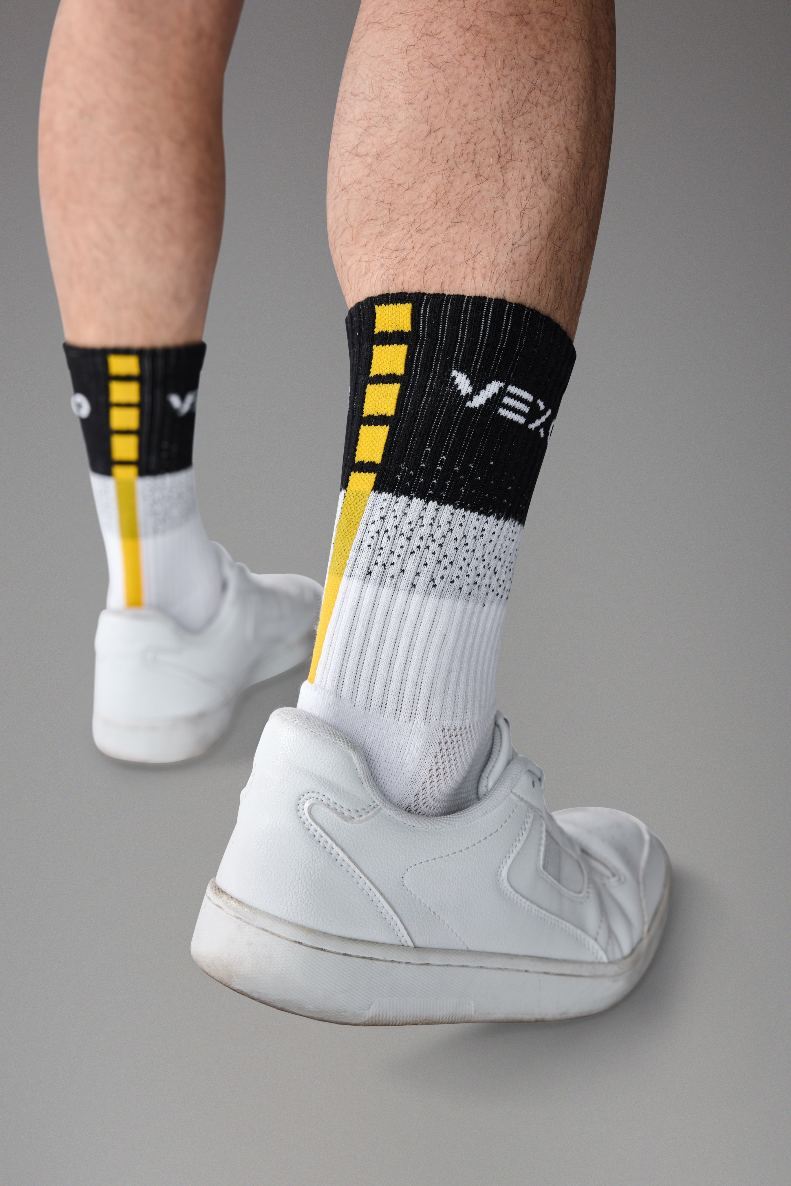 man wearing tennis socks with grip zones at the soles