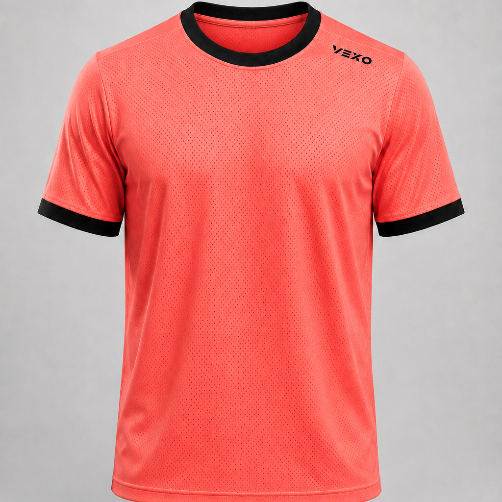 A coral red athletic t-shirt with black trim on the crew neck and sleeve cuffs, featuring a black VEXO logo on the left chest, displayed against a neutral gray background.